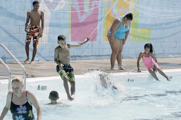 File Photo: Children jump into the Bridesburg Pool and Recreation Center on Richmond Street last summer. City pools start opening today.