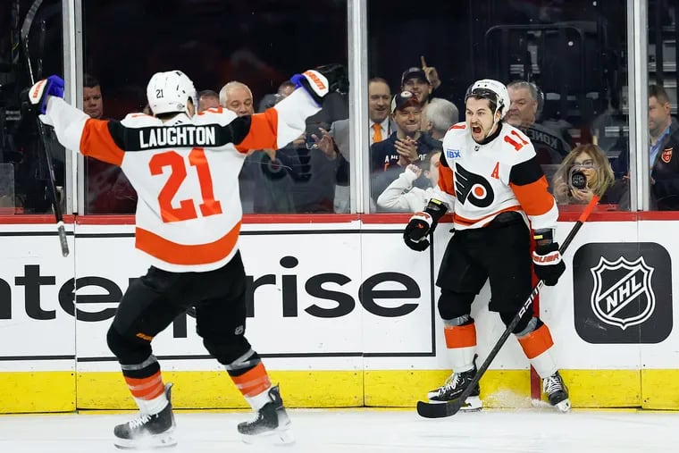 Flyers right wing Travis Konecny celebrates after scoring a second-period short-handed goal with teammate center Scott Laughton against the New Jersey Devils on Saturday.
