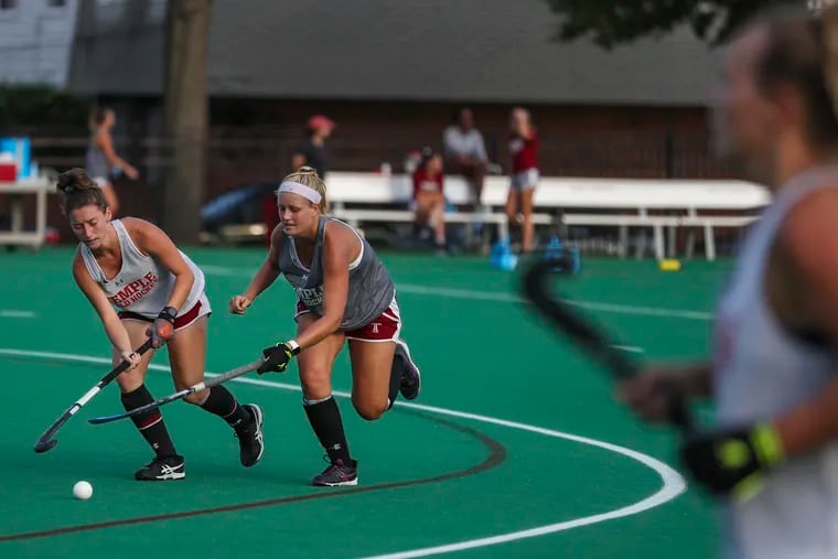 Mia Sexton (left) and Becky Gerhart battle for the ball during a Temple field hockey team practice in 2019.
