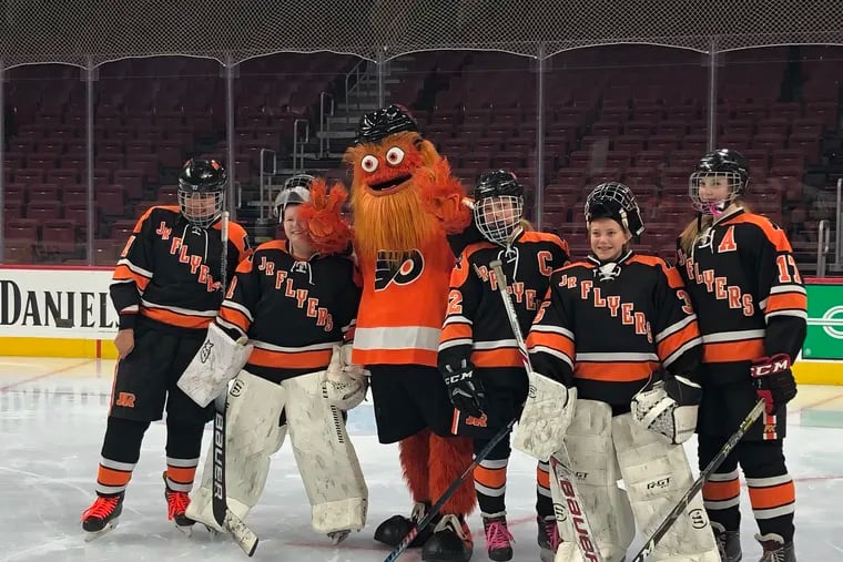 The Jr. Flyers pose with Gritty at the Flyers' Hockey for Her event on Wednesday, Feb. 6.