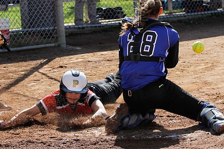 Hatboro-Horsham's Megan Hallock slides safely into home ahead of the
ball thrown to Quakertown catcher Maddie Calder (right) to score the
team's first run. (Michael S. Wirtz/Staff Photographer)