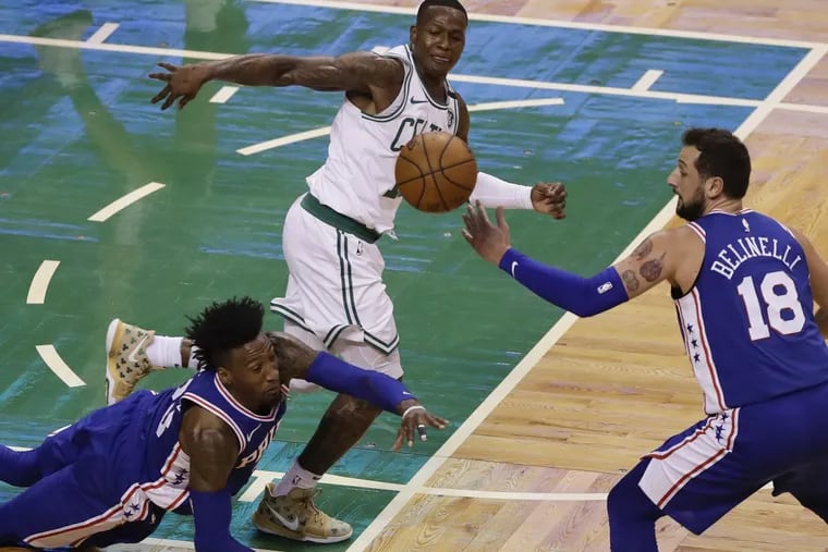 Celtics guard Terry Rozier passes the ball past Sixers forward Robert Covington and guard Marco Belinelli during the first quarter of the Sixers’ Game 2 loss.