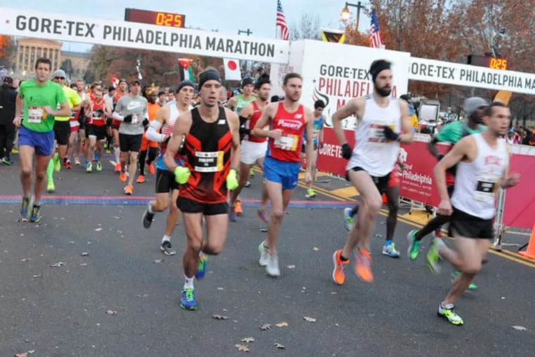 Runners take off at the Philadelphia Marathon starting line on the Benjamin Franklin Parkway in 2014.