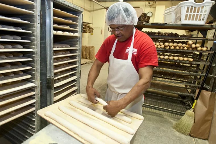 Gaudencio Saguilar works in the bakery at Formica Bros. Baking on 2310 Arctic Avenue in Atlantic City. The 95-year old family-owned bakery and the largest bread supplier to the AC casinos has taken a hit with casino closings. (RON TARVER/Staff Photographer)