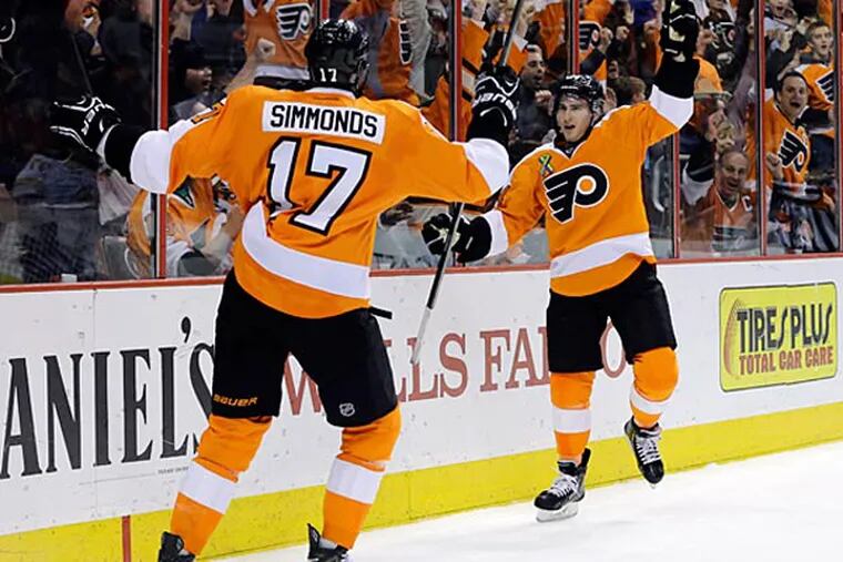 Philadelphia Flyers' Matt Read, right, and Wayne Simmonds celebrate after Read's goal during the second period of an NHL hockey game against the Boston Bruins, Tuesday, April 23, 2013, in Philadelphia. (AP Photo/Matt Slocum)