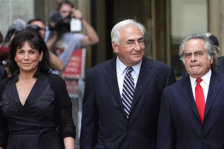 Former International Monetary Fund leader Dominique Strauss-Kahn, center, leaves Manhattan state Supreme court with his wife Anne Sinclair, left, and attorney Benjamin Brafman after a hearing Tuesday, Aug. 23, 2011 in New York. A New York judge dismissed the sexual assault case against Strauss-Kahn, but the order is on hold until an appeals court rules on his accuser's request for a special prosecutor. (AP Photo / Mary Altaffer)