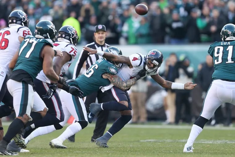 Chris Long (center) sacks Texans quarterback Deshaun Watson, forcing a fumble, during the fourth quarter of Sunday's game.