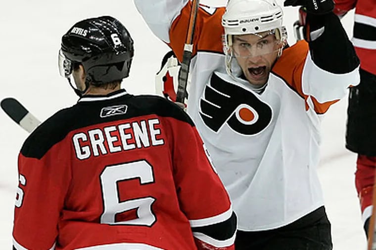 Jeff Carter celebrates after Simon Gagne scored the game-winning goal in overtime. (Rich Schultz/AP)