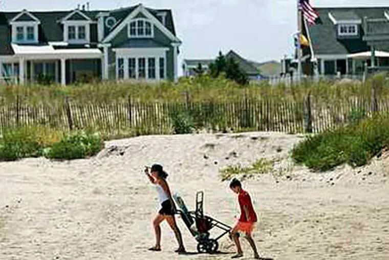 With the reopening of the beaches along 9th to 29th Streets in Avalon, N.J., vacationers march out to the water rolling their beach possessions with them. (Michael Bryant/Inquirer)