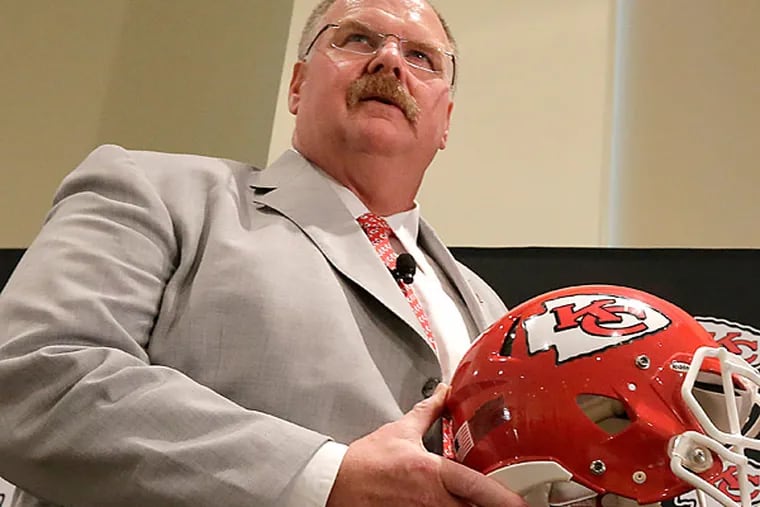 New Kansas City Chiefs NFL team head football coach Andy Reid, left, and owner Clark Hunt pose for photographers during a news conference at Arrowhead Stadium Monday, Jan. 7, 2013, in Kansas City, Mo. (AP Photo/Charlie Riedel)
