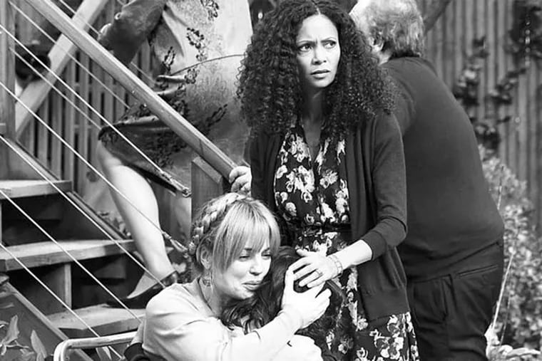 Melissa George (left) is an upset mom holding her child (Dylan Schombing) after the boy has been slapped at a party (thrown by Thandie Newton, right) by an adult, setting off a string of consequences.