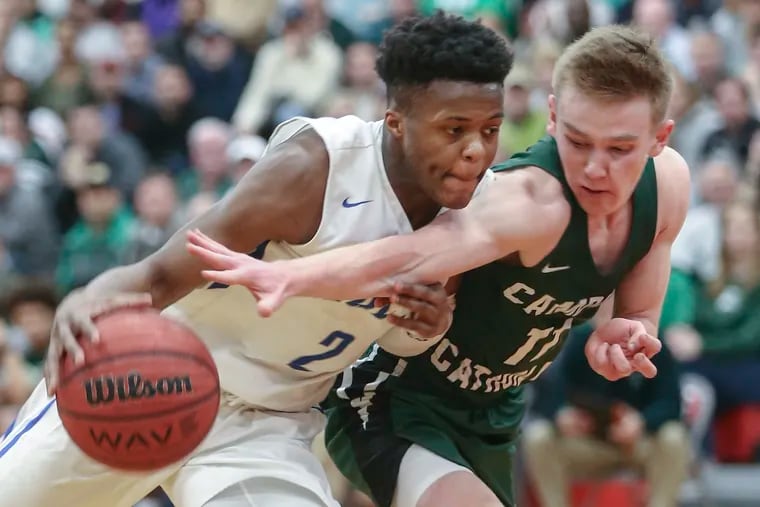 Camden Catholic's Patrick Corbett (right, defending against Paul VI's Tyshon Judge) and his fellow seniors are reaching for a state title in their last season.