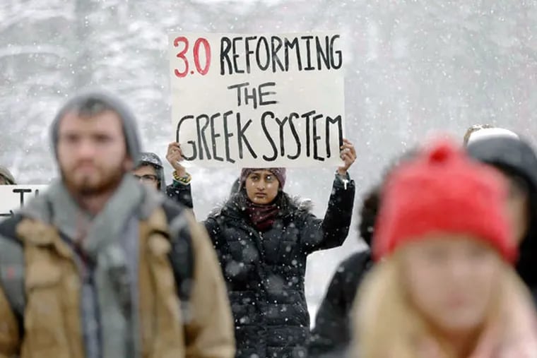 Protesters gathering at Penn State on Friday to denounce allegations that students at a fraternity there had posted nude photos of sleeping or unconscious women on private Facebook pages. (MATT ROURKE / AP)