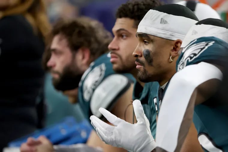 Philadelphia Eagles quarterback Jalen Hurts sits on the bench late in the fourth quarter. Eagles lose 33-13 to the Cowboys at AT&T Stadium in Arlington, Texas on Sunday, Dec. 10, 2023.