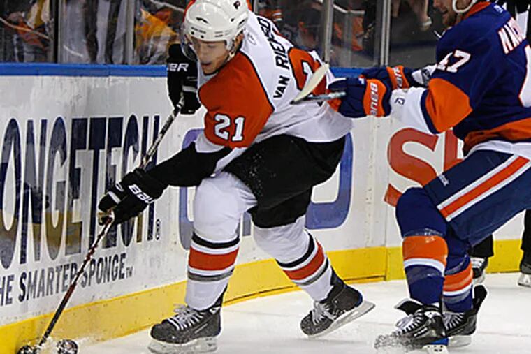 Islanders defenseman Andrew MacDonald tries to stop James van Riemsdyk in the second period. The Flyers won 2-1. (AP Photo/Kathy Willens)