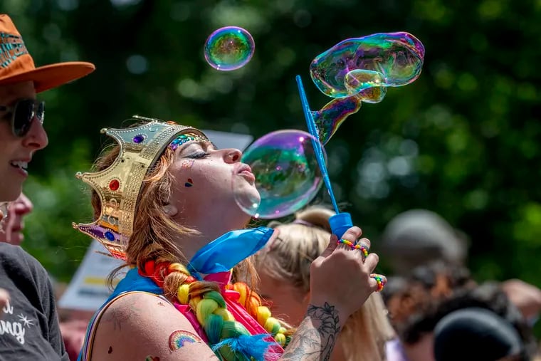 Ally Dua of Williamstown, NJ, blows bubbles along  the Walnut Street march route as thousands of people celebrate queerness and the start of Pride Month at the Pride March and Festival in Center City Sunday, June 4, 2023.