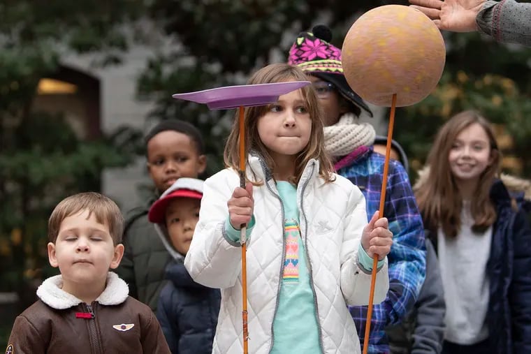 Victoria Torres of Blue Bell , participates in spinning a plate and a ball on a stick, during a street jugglers performance at Philadelphia City Hall.