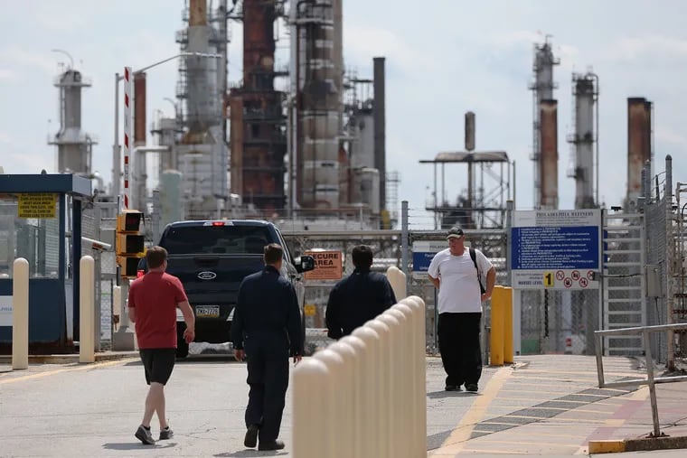 Workers enter and leave the Philadelphia Energy Solutions refinery in South Philadelphia on Aug. 20, 2019, the day the company announced it was laying off most of its workers at the complex.