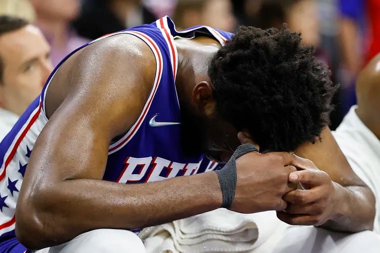 Sixers center Joel Embiid sits with head down on the bench after the Sixers lost their second-round Eastern Conference playoffs series to the Miami Heat on Thursday, May 12, 2022 in Philadelphia.