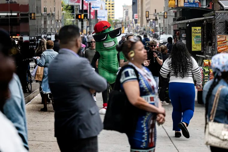 Dilly the pickle walks in Center City. The big pickle is the mascot for the Big Dill carnival party events, soon to host a big gathering in the city.