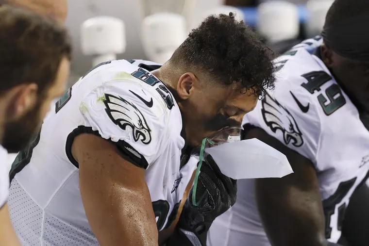 Eagles tight end Josh Perkins breathes oxygen while on the bench during a preseason game against the New York Jets on Thursday, August 30, 2018.