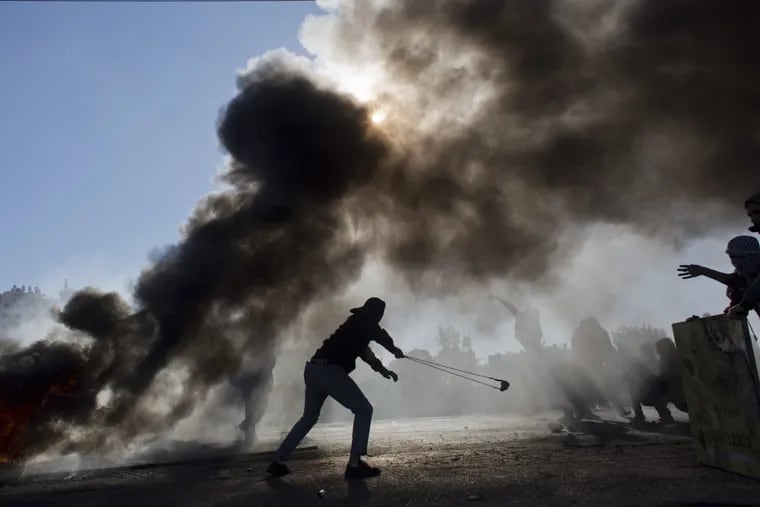Palestinian protesters burn tires and clash with Israeli troops in Ramallah Friday following protests against President Trump’s decision to recognize Jerusalem as the capital of Israel.