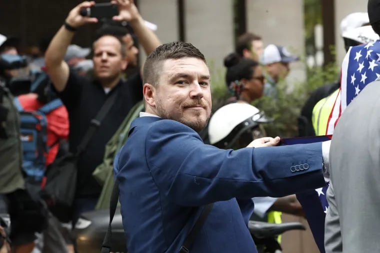 White nationalist Jason Kessler walks alongside a small group of supporters to the White House to rally on the one year anniversary of the Charlottesville "Unite the Right" rally, Sunday, Aug. 12, 2018, in Washington.