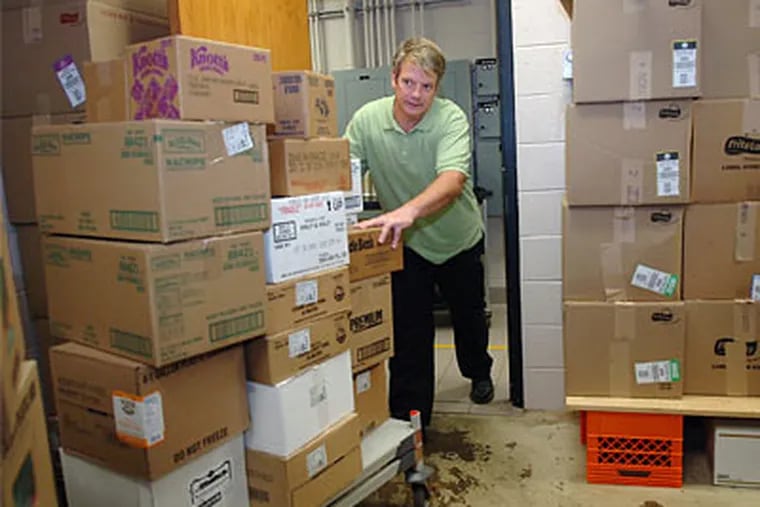 Russell Dilkes, Food Service Coordinator at Radnor High, brings food supplies into the dry storage area. (Sharon Gekoski-Kimmel / Inquirer)