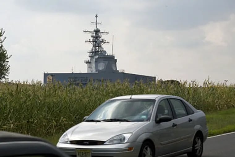 Lockheed Martin and the U.S. Navy are working together at a joint facility in Moorestown, developing and improving Aegis ship defense technology. In this photo, traffic on Hartford Road races past the Navy's Command Systems Engineering Center, nickamed "The cornfield carrier." (Ed Hille/Inquirer)
