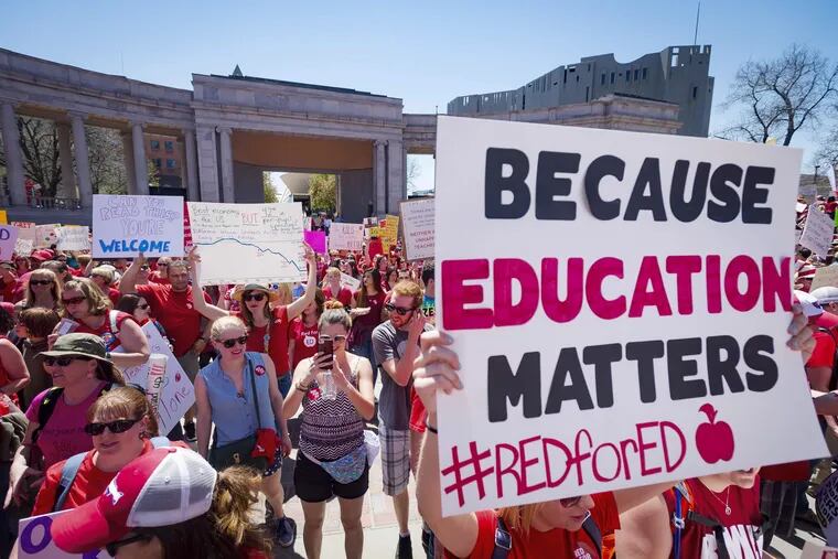 A sign reads "Because education matters, #redfored" as thousands of teachers and supporters begin an April rally in Denver. Teachers nationwide are hoping for a "blue wave" at the polls but in Pennsylvania the largest statewide teachers' union has backed Republicans in some key races.