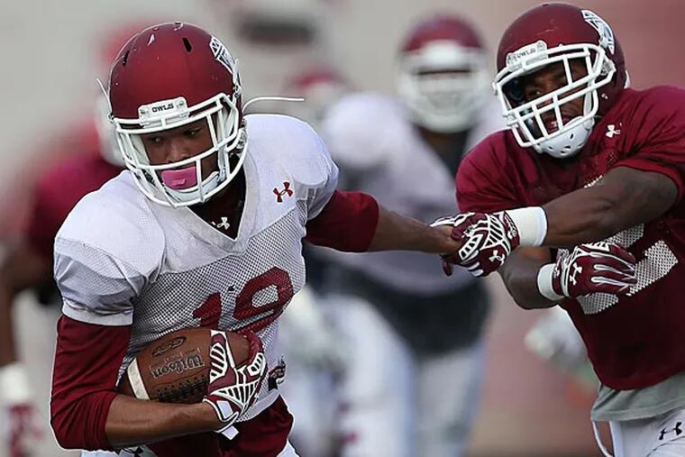 Keith Kirkwood (left) catches a pass during a Temple practice. (David Maialetti/Staff Photographer)