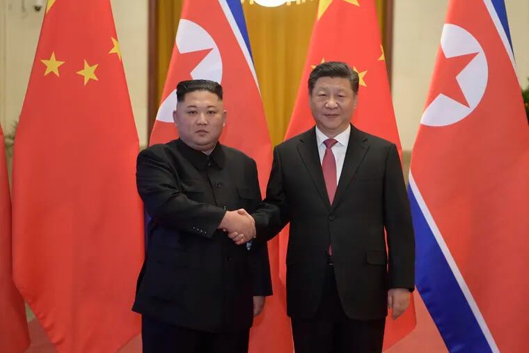 In this Tuesday, Jan. 8, 2019, photo released by China's Xinhua News Agency, North Korean leader Kim Jong Un (left) and Chinese President Xi Jinping shake hands as they pose for a photo before talks at the Great Hall of the People in Beijing. A special train believed to be carrying Kim Jong Un departed Beijing on Wednesday after a two-day visit by the North Korean leader to the Chinese capital. (Li Xueren/Xinhua via AP)