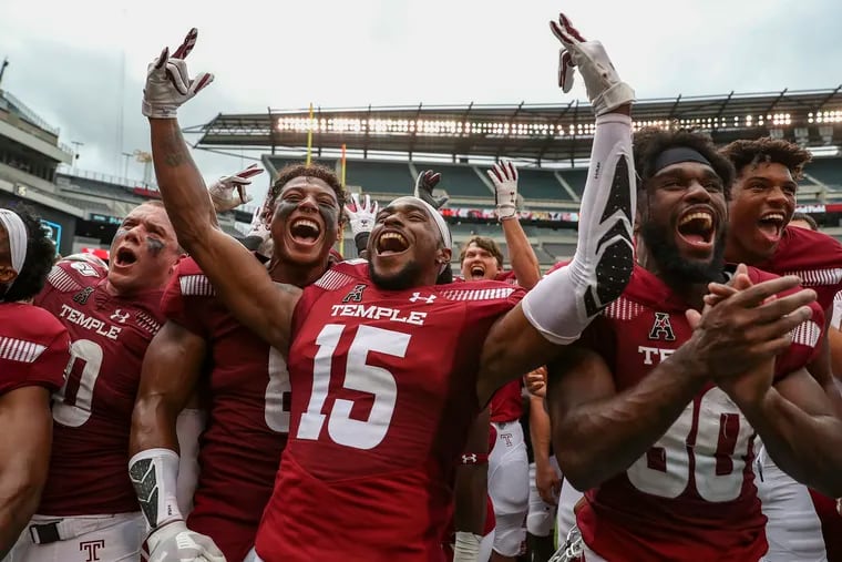 Temple players celebrate with their fans after defeating Maryland.