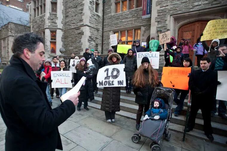 Eric Santoro reads a statement Wednesday during a protest organized by angry parents on the University of Pennsylvania's campus. The university's partner elementary school, Penn Alexander, is using a lottery system to deny some neighborhood children admission. (Ron Tarver / Staff Photographer)