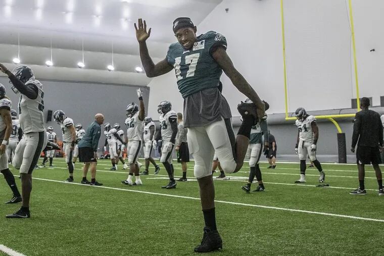 Eagle wide receiver, #17, Alshon Jeffery, right, along with the rest of the team, stretch at the begining of practice at the indoor practice facility because of the rain on Monday. Eagles hold practice indoors due to the rain on Monday 08/07/2017 MICHAEL BRYANT / Staff Photographer