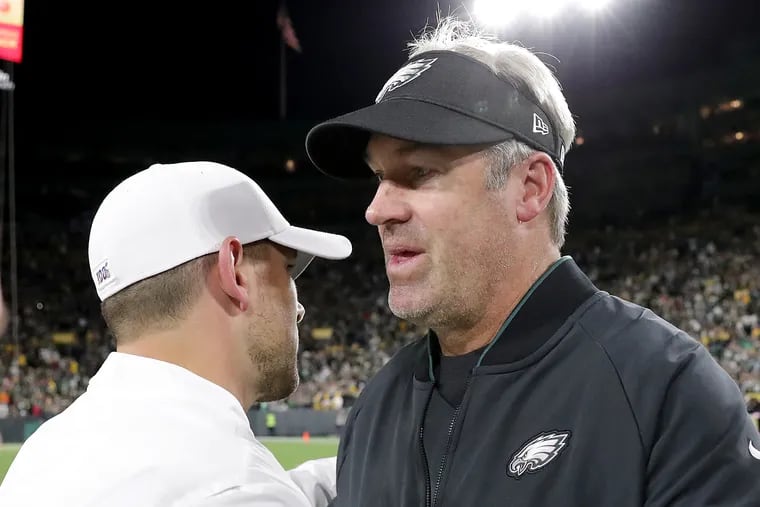 Eagles head coach Doug Pederson (right) embraces Packers head coach Matt LaFleur after the Eagles' win on Thursday night.