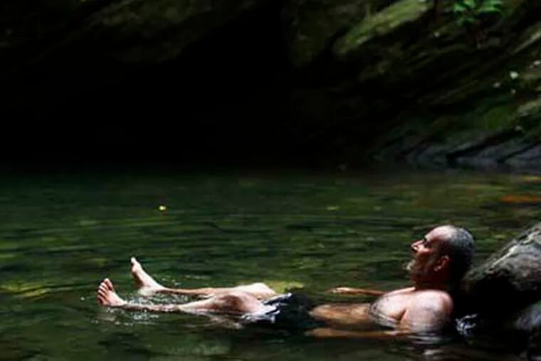 A bather beats the midday heat at the Devil's Pool in Wissahickon Valley Park Wednesday, July 20, 2011, in Philadelphia. (AP Photo/Matt Rourke)