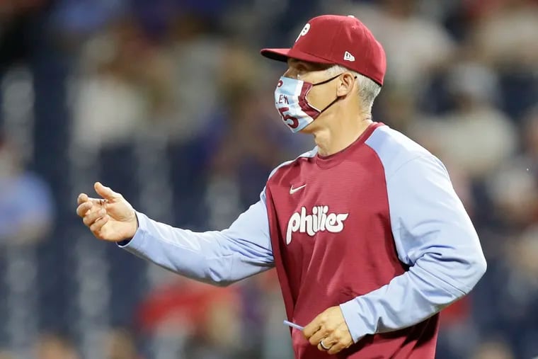 Phillies manager Joe Girardi reaches out for the baseball during a pitching change against the Miami Marlins on Thursday, May 20, 2021 in Philadelphia.