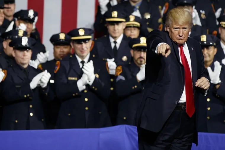 President Donald Trump points to the crowd after speaking to law enforcement officials on the street gang MS-13, Friday, July 28, 2017, in Brentwood, N.Y. (AP Photo/Evan Vucci)