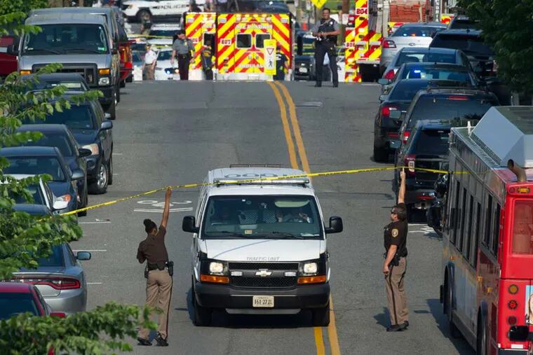 Police and emergency personnel are seen near the scene where House Majority Whip Steve Scalise of La. was shot during a Congressional baseball practice in Alexandria, Va., Wednesday, June 14, 2017.