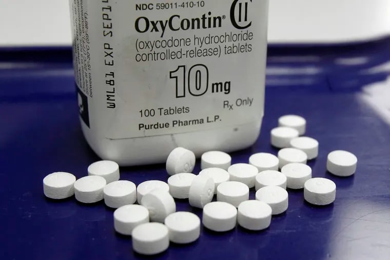 FILE - This Feb. 19, 2013, file photo shows OxyContin pills arranged for a photo at a pharmacy in Montpelier, Vt. Oklahoma's attorney general will announce a settlement Tuesday, March 26, 2019, with Purdue Pharma, one of the drug manufacturers named in a state lawsuit that accuses them of fueling the opioid epidemic.