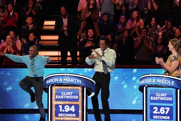 Temple professor Aaron Smith (left) and his brother, Martin, a New Jersey math teacher, celebrate having buzzed in first with a correct answer in Monday's season premiere of Fox's "Beat Shazam."