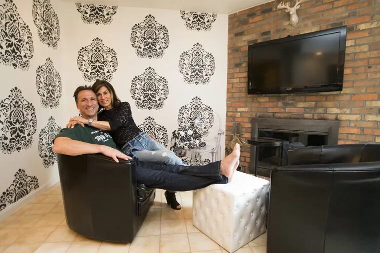 Chris and Sherri Theodore relax in the television room off the kitchen of their Ardmore condo on May 5, 2017.