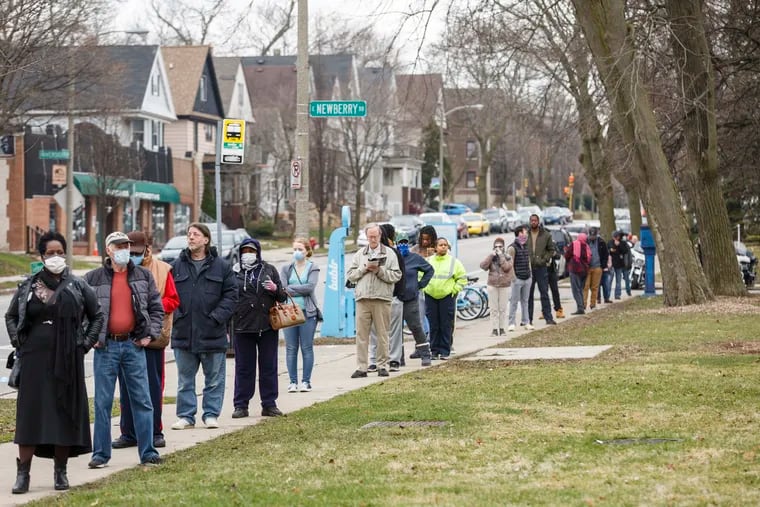 A line to vote in Wisconsin's spring primary election wraps around blocks Tuesday, April 7, 2020, in Milwaukee. MUST CREDIT: Photo for The Washington Post by Sara Stathas