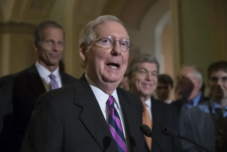 Senate Majority Leader Mitch McConnell (R.,Ky.) flanked by Sen. John Thune (R., S.D.) the Republican Conference chairman (left) and Sen. Roy Blunt (R., Mo.) laughs as he holds his first news conference since the Republican health care bill collapsed.