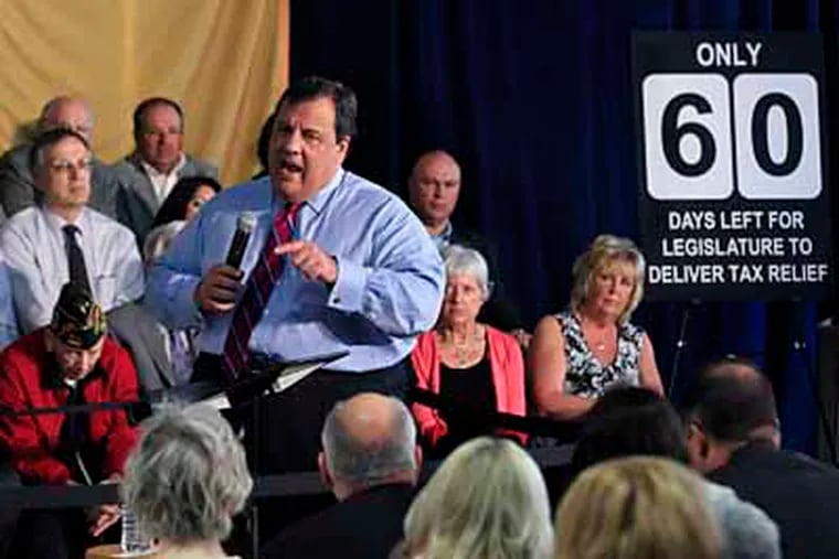New Jersey Gov. Chris Christie stands near a sign counting the days left in the legislative session as he addresses a gathering at a town hall meeting in Garfield, N.J., Wednesday, May 2, 2012. (AP Photo/Mel Evans)