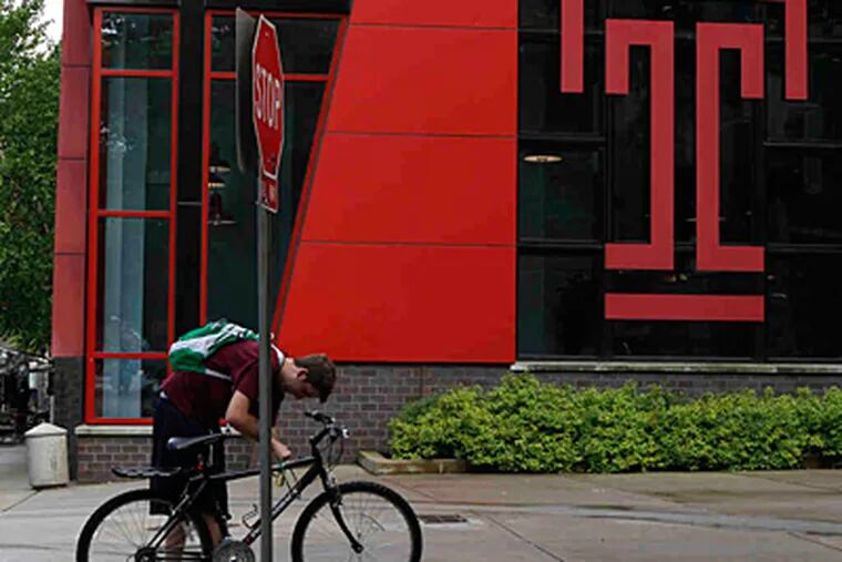 A student with his bike on Temple University's campus.