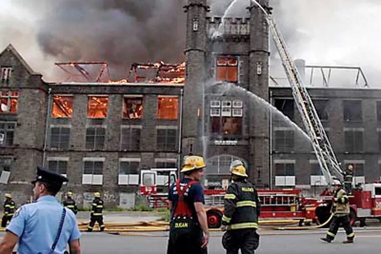 Philadelphia firefighters battle a blaze last year at the Julia de Burgos school on Lehigh Avenue in North Philadelphia. (David Maialetti / Staff Photographer)