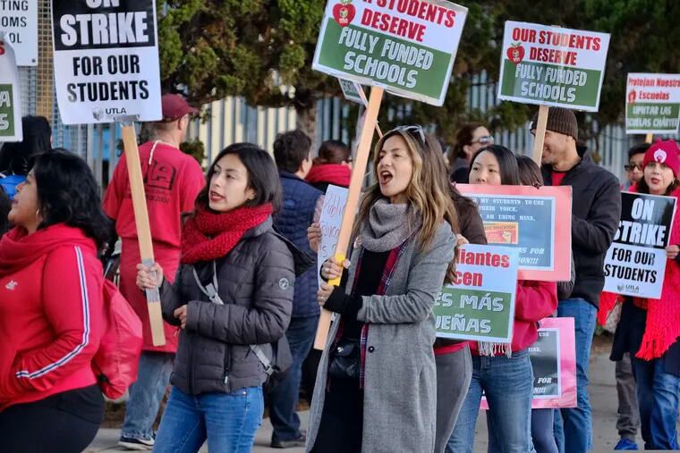 Striking Los Angeles Unified District teachers are joined by parents and students in front of Evelyn Thurman Gratts Elementary School in Los Angeles on Tuesday.