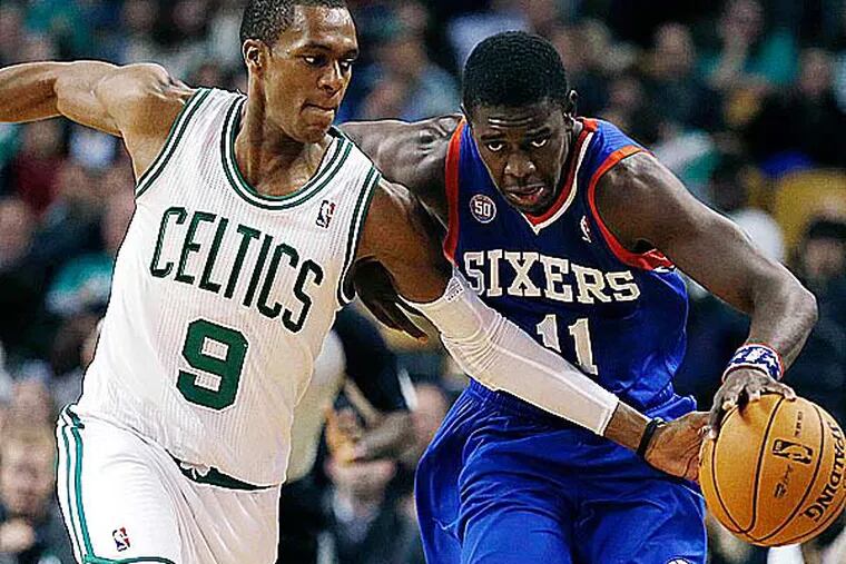 Rajon Rondo (9) tries to steal the ball from Jrue Holiday (11) in the fourth quarter of an NBA basketball game in Boston, Friday, Nov. 9, 2012. The 76ers won 106-100. (Michael Dwyer/AP)